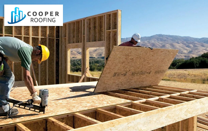 Plywood roofing sheets being installed on a house under construction